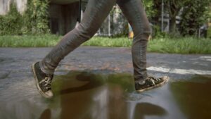 ellie's shoes splashing on a puddle of water as she runs through the street